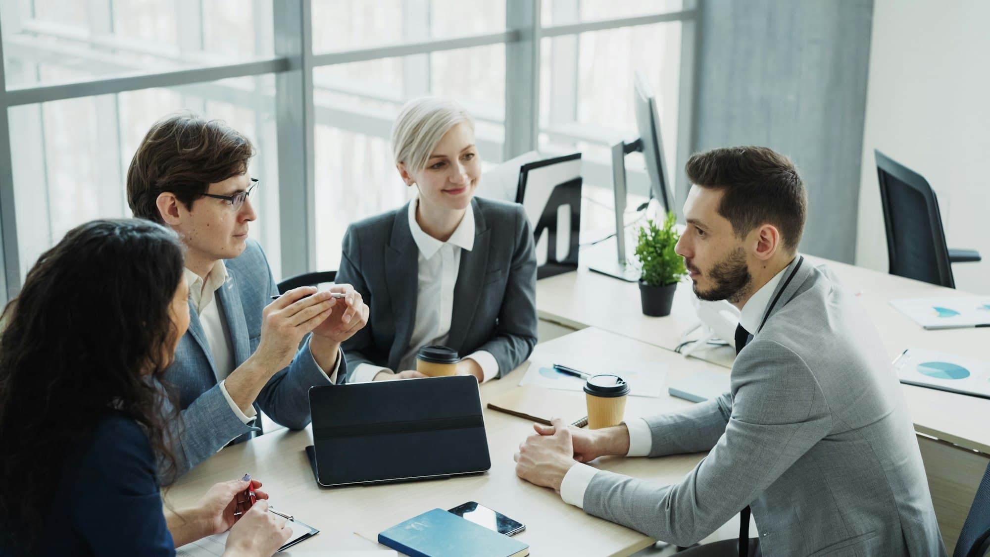 A lawyer talking a client through their matter across a meeting table
